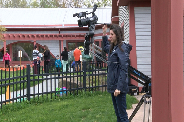 Student and production intern Jess Marciante works with Production Specialist Ken Measimer in 2017 to capture footage from Fun Mud Day, an annual event held at Eastern’s Child and Family Development Resource Center.