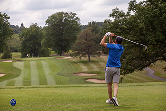 golfer tees off