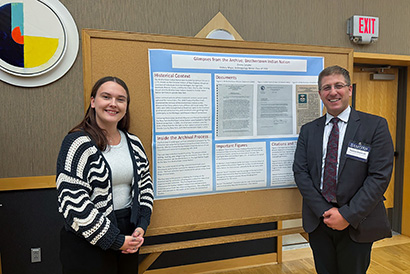 History student Emma Schafer and Prof. Balcerksi by Schafer's presentation poster