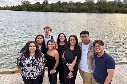 Students gather in front of the Potomac River.