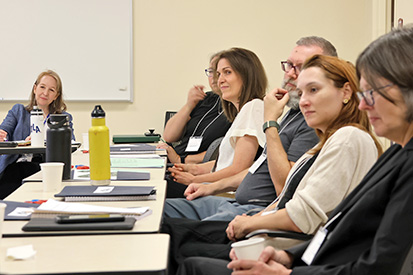 A group of new full-time faculty members attend a faculty orientation..