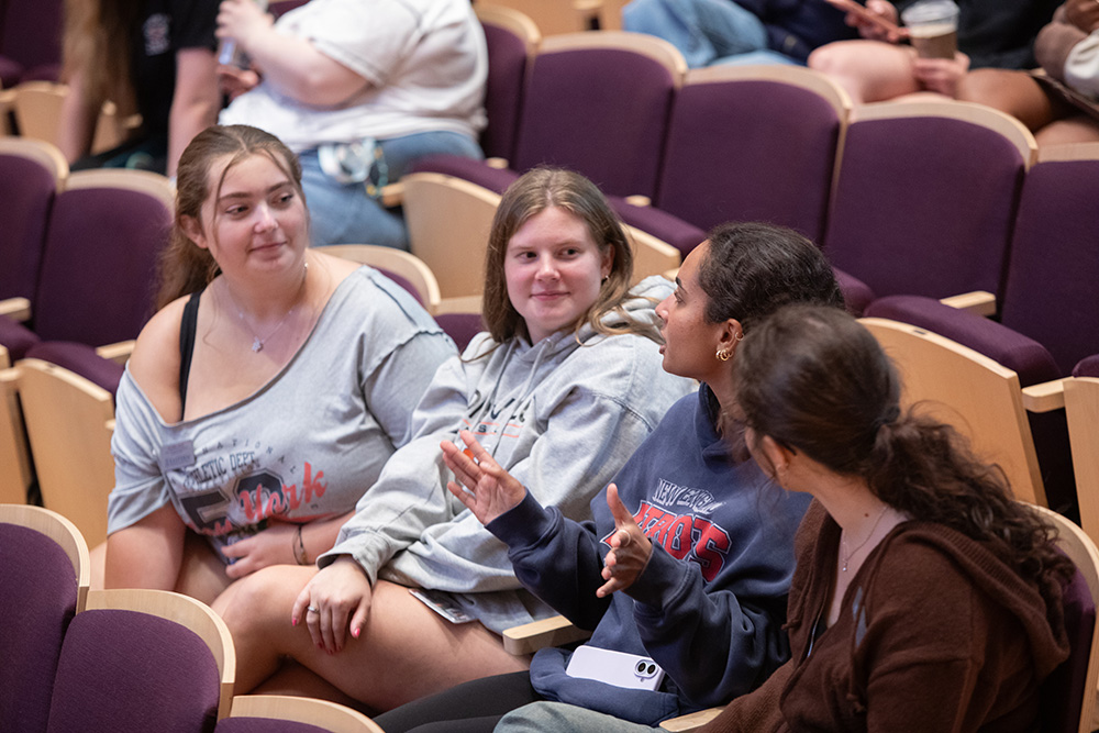 A group of RAs chitchat in the Concert Hall