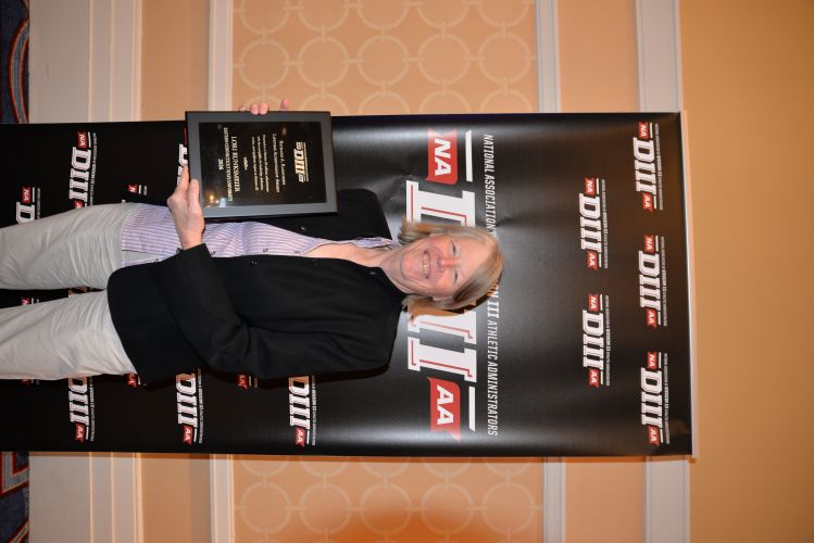 Lori Runksmeier receives the Richard A. Rasmussen Lifetime Achievement Award at the NCAA Convention in January 2026.