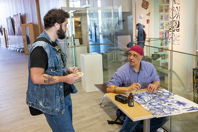 Danny Killion shows an attendee his free-range pen and ink drawing