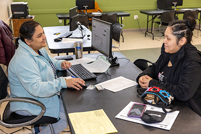 A volunteer assists a community member in tax filing at VITA's Windham Heights Learning Center site.