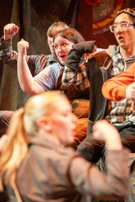 Cast members dance during a musical number.