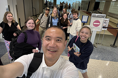Art Professor Tao Chen takes a photograph with students at NCUR.