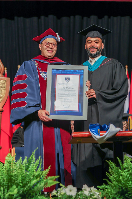 President Karim Ismaili presents Harold Tavares with the second annual Distinguished Public Service Award.
