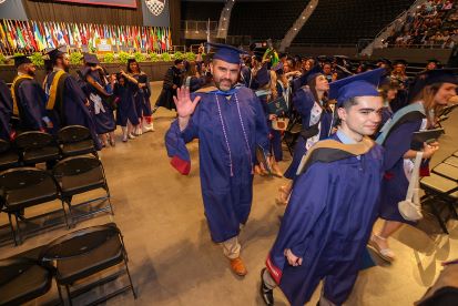 Happy graduates leave the ceremony with master's degrees.