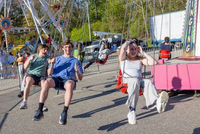 Students ride swings at the Spring Fest carnival.