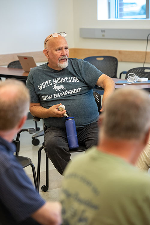 Peter Civitello, department head of Auto Mechanics at Ella T. Grasso Technical High School, speaks during a workshop session.