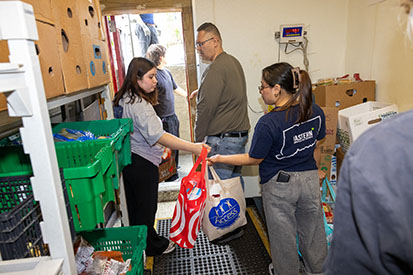 Summer Civic Leadership Program students organize and distribute donated food at Covenant Soup Kitchen.
