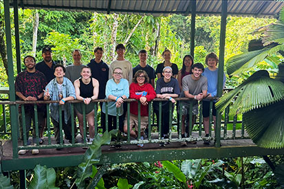 Students from "Tropical Biology" and "Tropical Ecosystems," stand on a bridge in the Costa Rican rainforest.