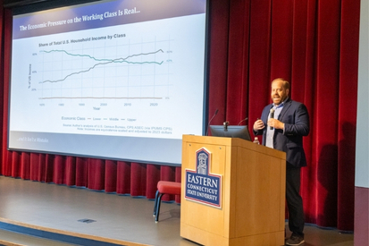 Chris Rivers explaining a graph on corporate profits and wages