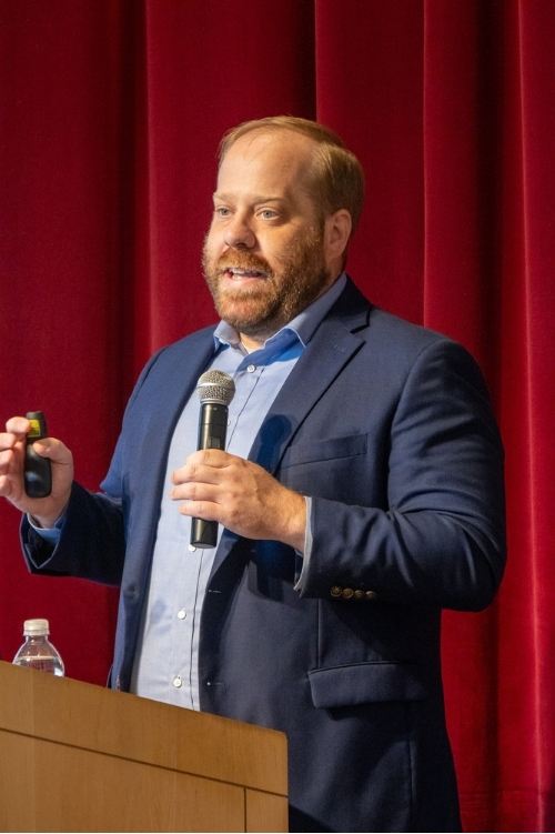 Chris Rivers speaking at a podium