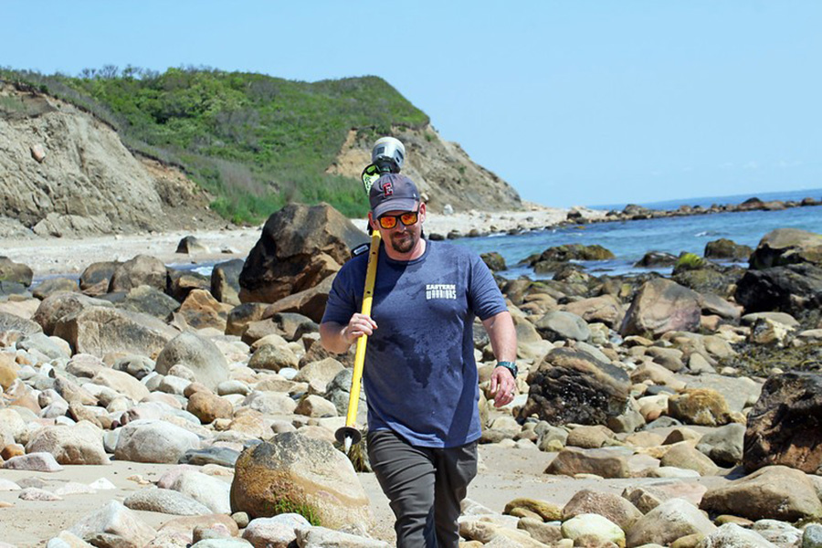 Oakley walks along the coast of Block Island. 