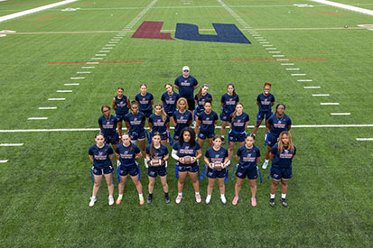 Eastern's women's flag football team on their new field at the Mansfield Athletic Outdoor Complex.