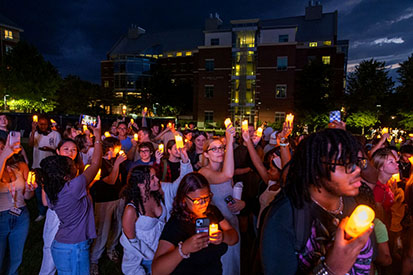 Students raise their candles during "Light the Way."