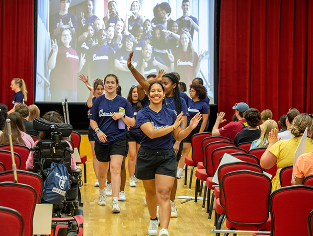 students walking down the aisle during a SOAR presentation