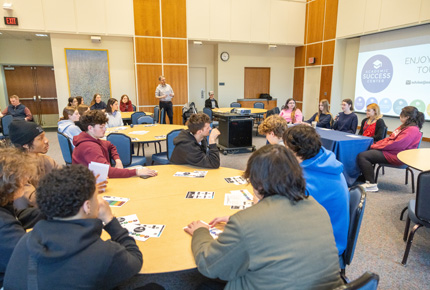 students sitting at tables during a presentation