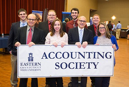 Members of the Accounting Society holding a banner