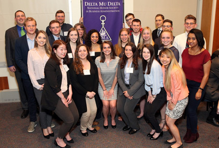 Members of Delta Mu Delta posing for a photo