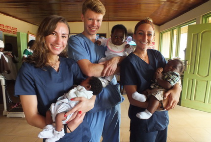 Students holding children in Ghana