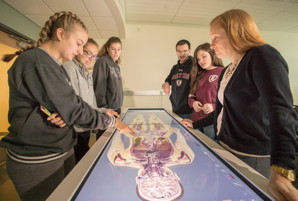 Students looking at a dissection table