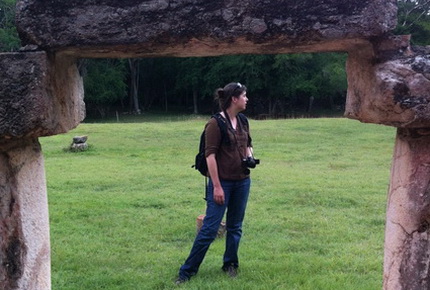 Student posing for a photograph under an arch in Spain