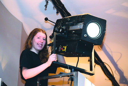 Student handling a stage light