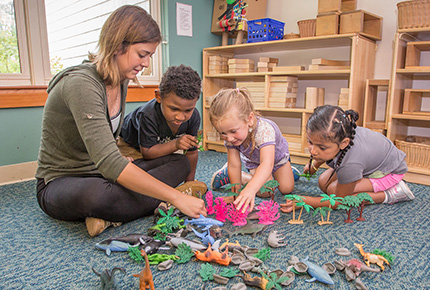 Teacher and children playing