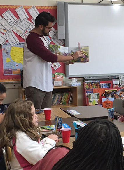 Teacher reading book to children