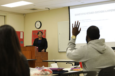 Professor answering question from student with raised hand