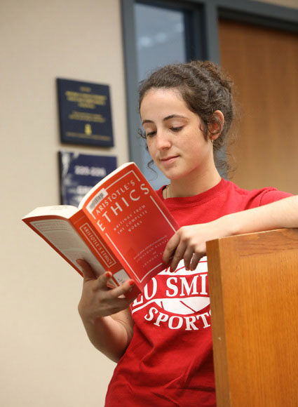 Student reading ethics book