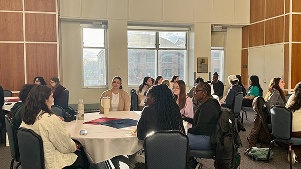 students sitting at tables having discussions