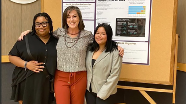 professor and two students posing for a photo