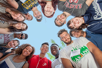 students circled around the edge of the photo, looking down at the viewer