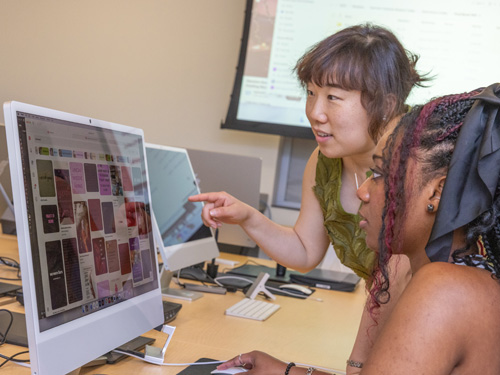 Lora Lee working with a student on a computer