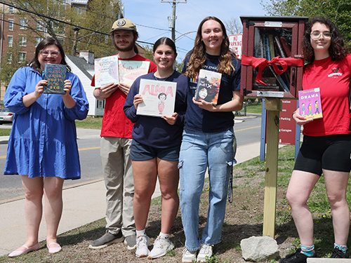 Allison Speicher and students holding books