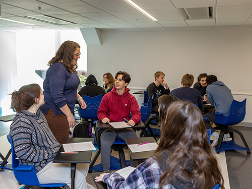 Caitlin Vasquez-O'Brien working with students in a classroom