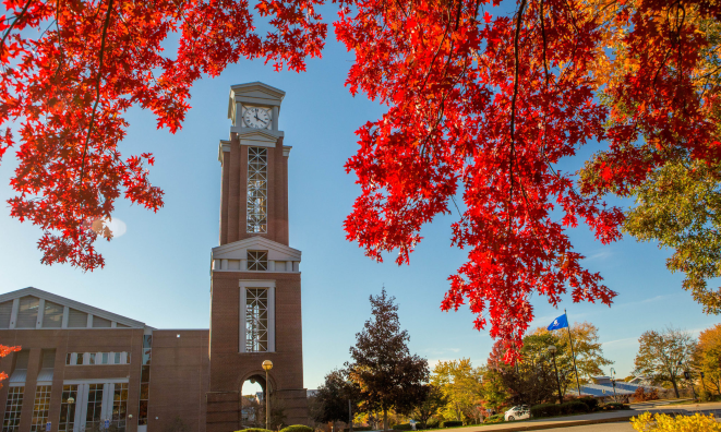 image of eastern's clock tower with fall foliage in the foreground