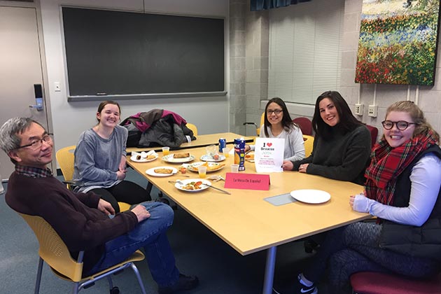 Students and professor promoting the Spanish Club