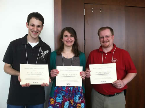 students holding award